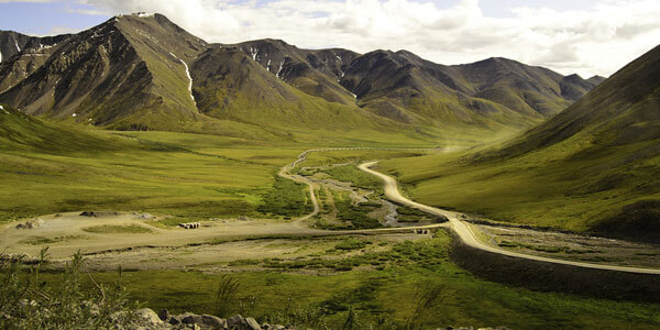 Alaska pipeline in green valley
